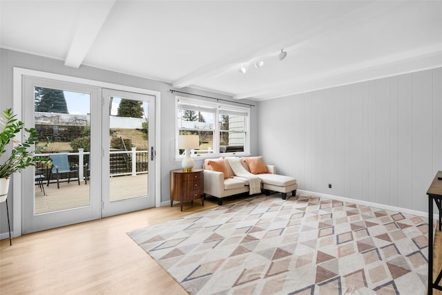 sunroom / solarium featuring beam ceiling