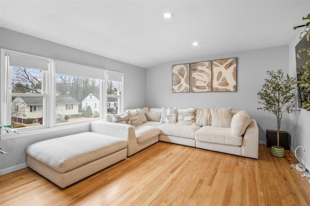 living room featuring baseboards, wood finished floors, and recessed lighting