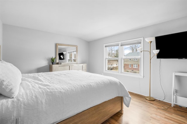 bedroom featuring wood finished floors and baseboards