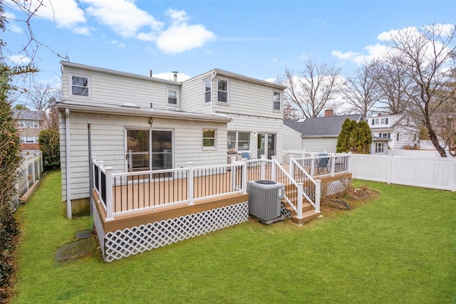 rear view of property with a fenced backyard, central AC, a yard, a wooden deck, and a chimney