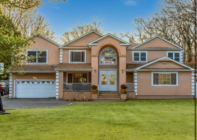 view of front of house featuring driveway, french doors, an attached garage, and stucco siding