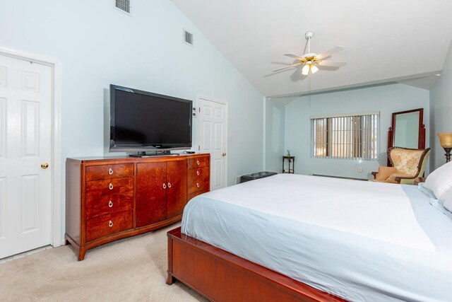 bedroom with lofted ceiling, light carpet, and visible vents