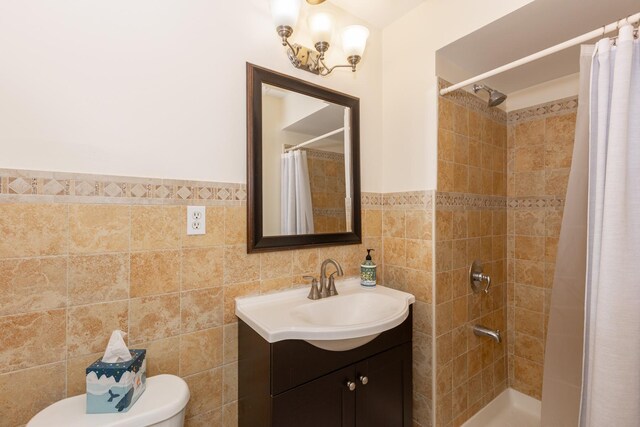 bathroom with a shower with curtain, wainscoting, tile walls, and vanity