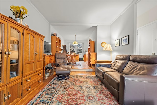 living room with crown molding and hardwood / wood-style floors