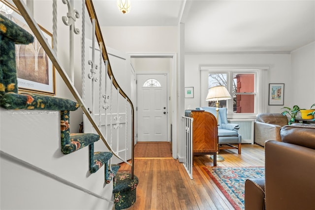 entryway featuring wood-type flooring and stairway