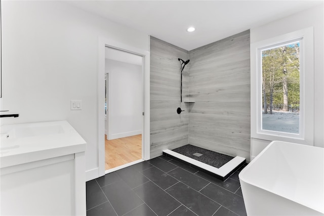 bathroom with tile patterned flooring, vanity, and separate shower and tub