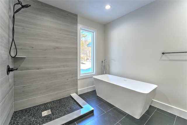 bathroom with tile patterned floors and shower with separate bathtub