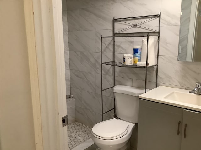 bathroom with vanity, tile walls, backsplash, and toilet