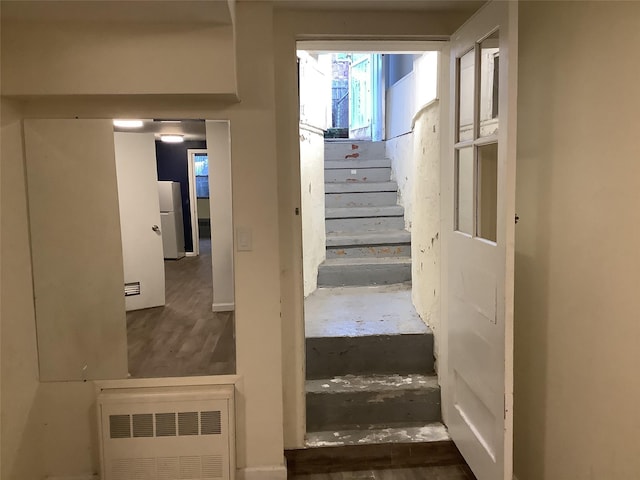 stairway with radiator and concrete floors