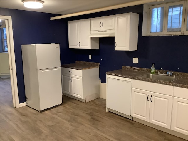 kitchen with sink, white appliances, wood-type flooring, and white cabinets