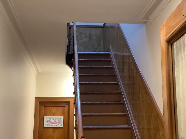 staircase featuring ornamental molding