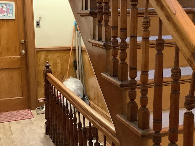 stairway with hardwood / wood-style flooring