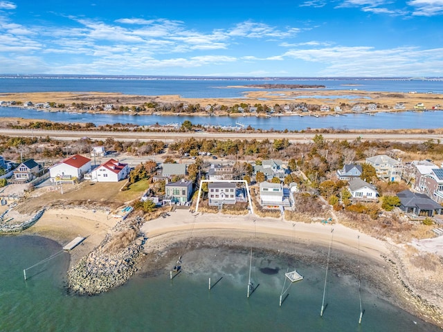 birds eye view of property with a beach view and a water view