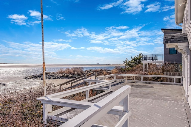 view of patio with a deck with water view