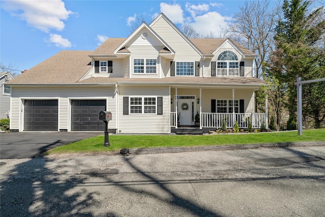 33 Potter Ln, Huntington, NY 11743 - view of front of home featuring an attached garage, covered porch, and driveway