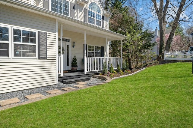 33 Potter Ln, Huntington, NY 11743 - property entrance featuring a yard, covered porch, and fence