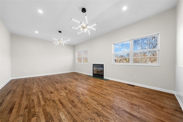 33 Potter Ln, Huntington, NY 11743 - unfurnished living room with a fireplace with flush hearth, recessed lighting, wood finished floors, visible vents, and a chandelier