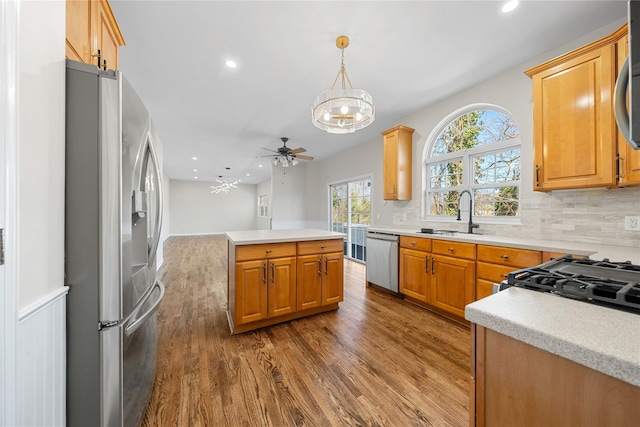 33 Potter Ln, Huntington, NY 11743 - kitchen with a sink, dark wood-style flooring, backsplash, light countertops, and appliances with stainless steel finishes