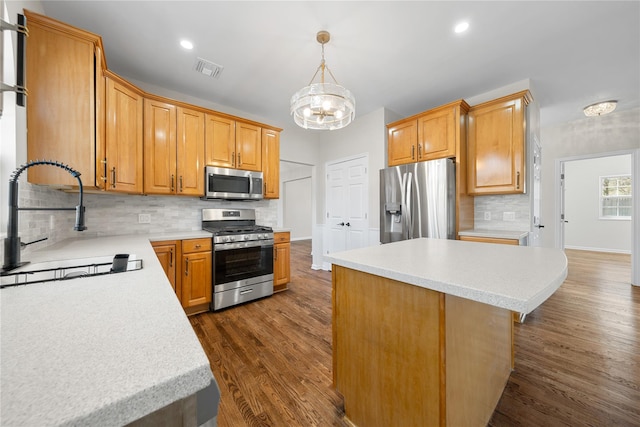 33 Potter Ln, Huntington, NY 11743 - kitchen featuring stainless steel appliances, light countertops, dark wood finished floors, a notable chandelier, and visible vents