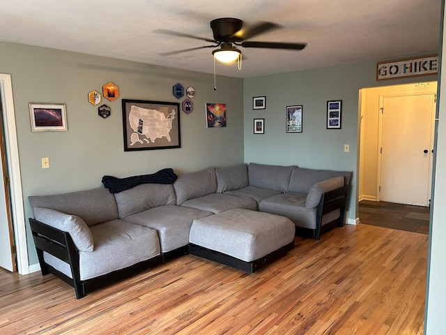 living room featuring ceiling fan and light wood-type flooring