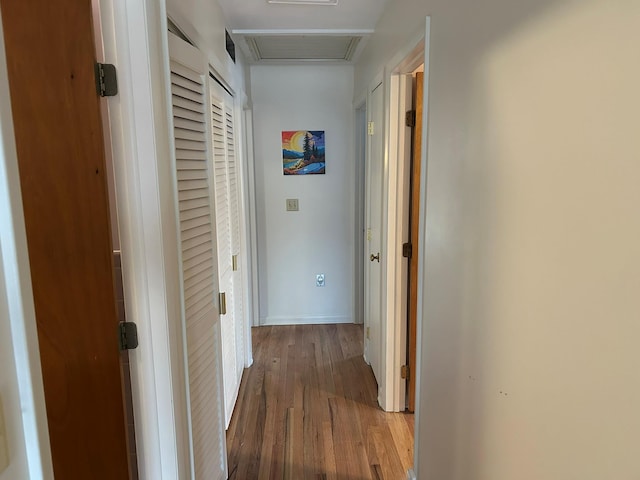 corridor with hardwood / wood-style floors