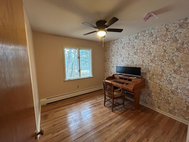 office area featuring ceiling fan, light wood-type flooring, and a baseboard heating unit