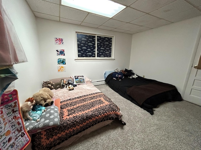 bedroom featuring baseboard heating, a paneled ceiling, and carpet