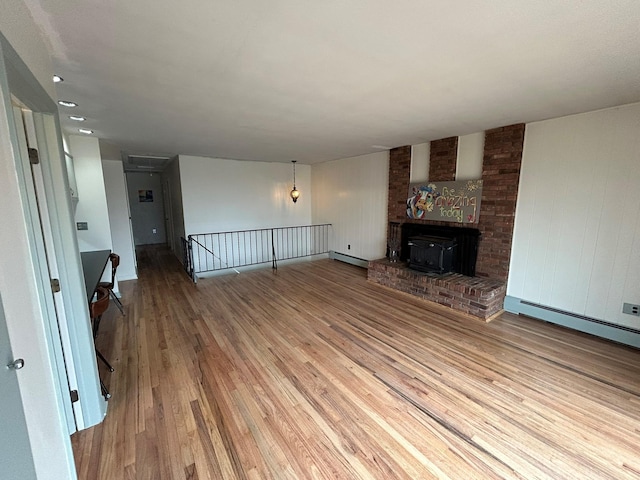 unfurnished living room featuring a baseboard radiator and light hardwood / wood-style floors