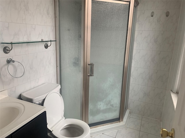 bathroom featuring vanity, tile walls, an enclosed shower, and toilet