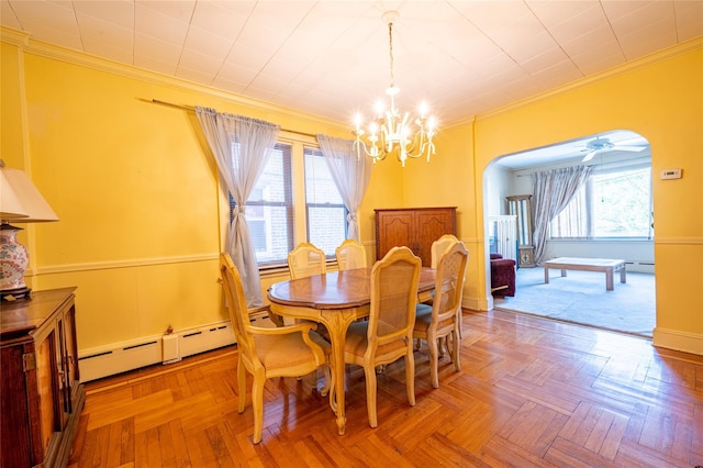 dining area featuring crown molding, parquet flooring, a wealth of natural light, and baseboard heating