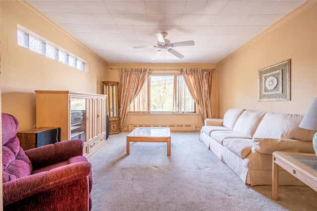 carpeted living room with a baseboard radiator, ceiling fan, and crown molding