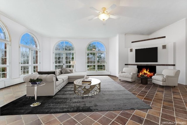 living room featuring vaulted ceiling and ceiling fan