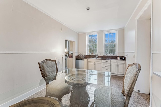 dining room featuring ornamental molding and sink