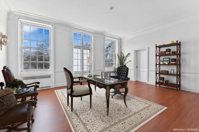 home office featuring dark wood-type flooring, radiator heating unit, and ornamental molding