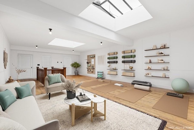 living room with a skylight, baseboards, wood finished floors, and beamed ceiling