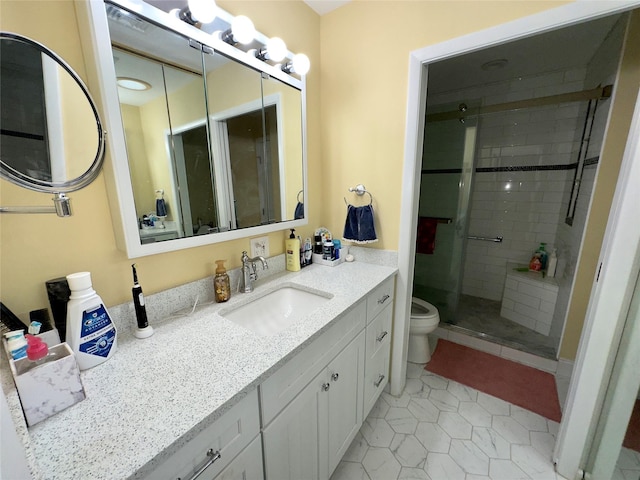 bathroom featuring vanity, toilet, tile patterned floors, and a shower with shower door