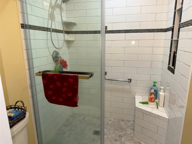 bathroom with an enclosed shower and toilet