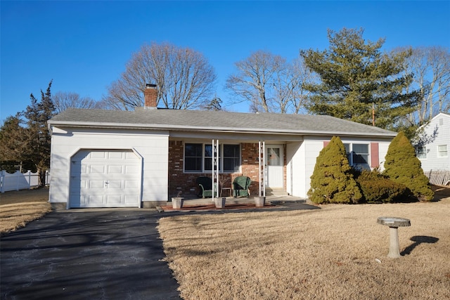 ranch-style home featuring a garage and covered porch