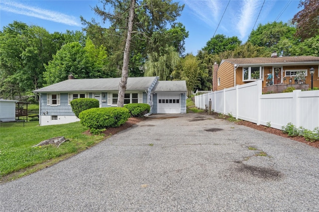 49 Pine Ave, Ossining, NY 10562 - ranch-style home with an attached garage, driveway, and a chimney