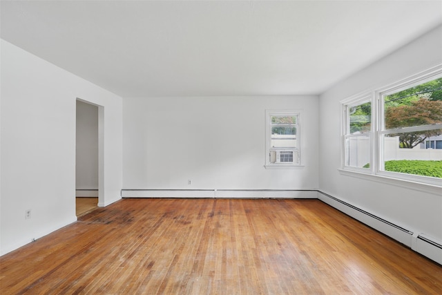 49 Pine Ave, Ossining, NY 10562 - spare room featuring wood-type flooring, a baseboard heating unit, and cooling unit