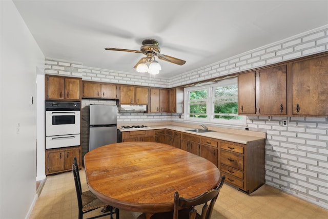 49 Pine Ave, Ossining, NY 10562 - kitchen with white appliances, a warming drawer, under cabinet range hood, and light flooring