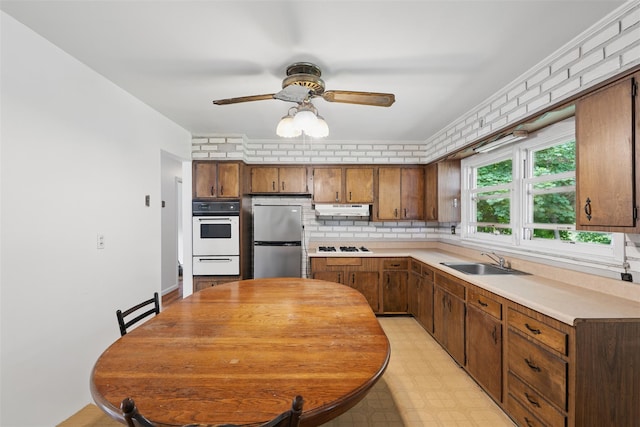 49 Pine Ave, Ossining, NY 10562 - kitchen featuring white appliances, a sink, under cabinet range hood, a warming drawer, and light countertops