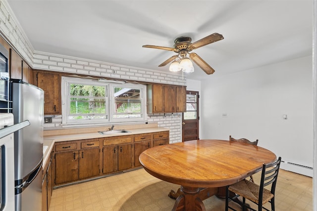 49 Pine Ave, Ossining, NY 10562 - kitchen featuring a sink, light floors, light countertops, ceiling fan, and a baseboard radiator