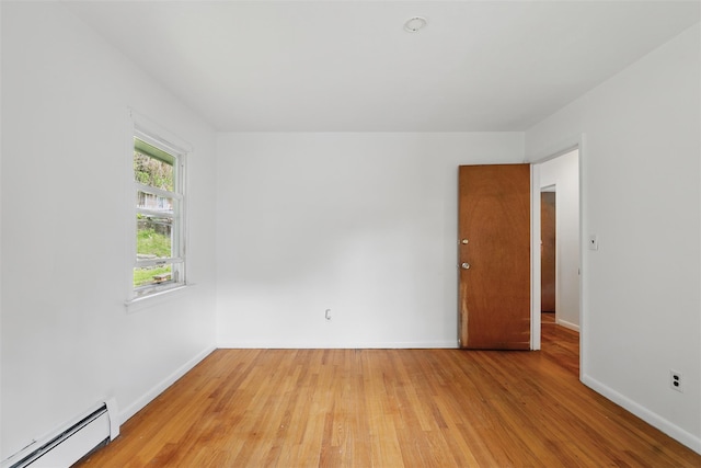 49 Pine Ave, Ossining, NY 10562 - unfurnished room with a baseboard radiator, light wood finished floors, and baseboards