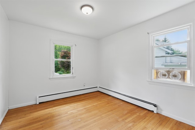 49 Pine Ave, Ossining, NY 10562 - empty room with a baseboard heating unit, light wood-style floors, and baseboards
