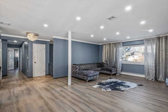 sitting room featuring crown molding, hardwood / wood-style floors, and baseboard heating