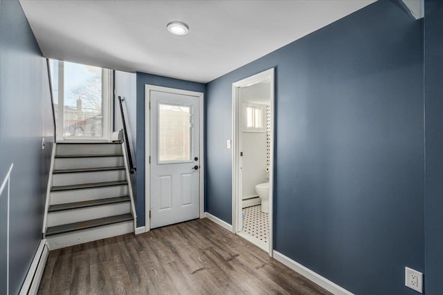 foyer featuring a baseboard heating unit and hardwood / wood-style flooring