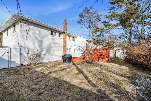 exterior space with a wooden deck and a lawn