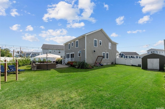 back of property with outdoor lounge area, a yard, and a shed