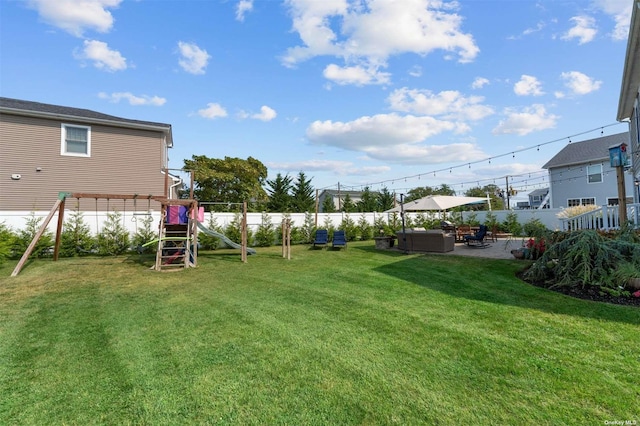 view of yard with a patio area and a playground